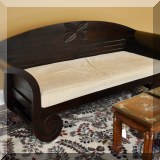 F10. Carved bench with arms and upholstered cushion. 34”h x 80”w x 28”d 